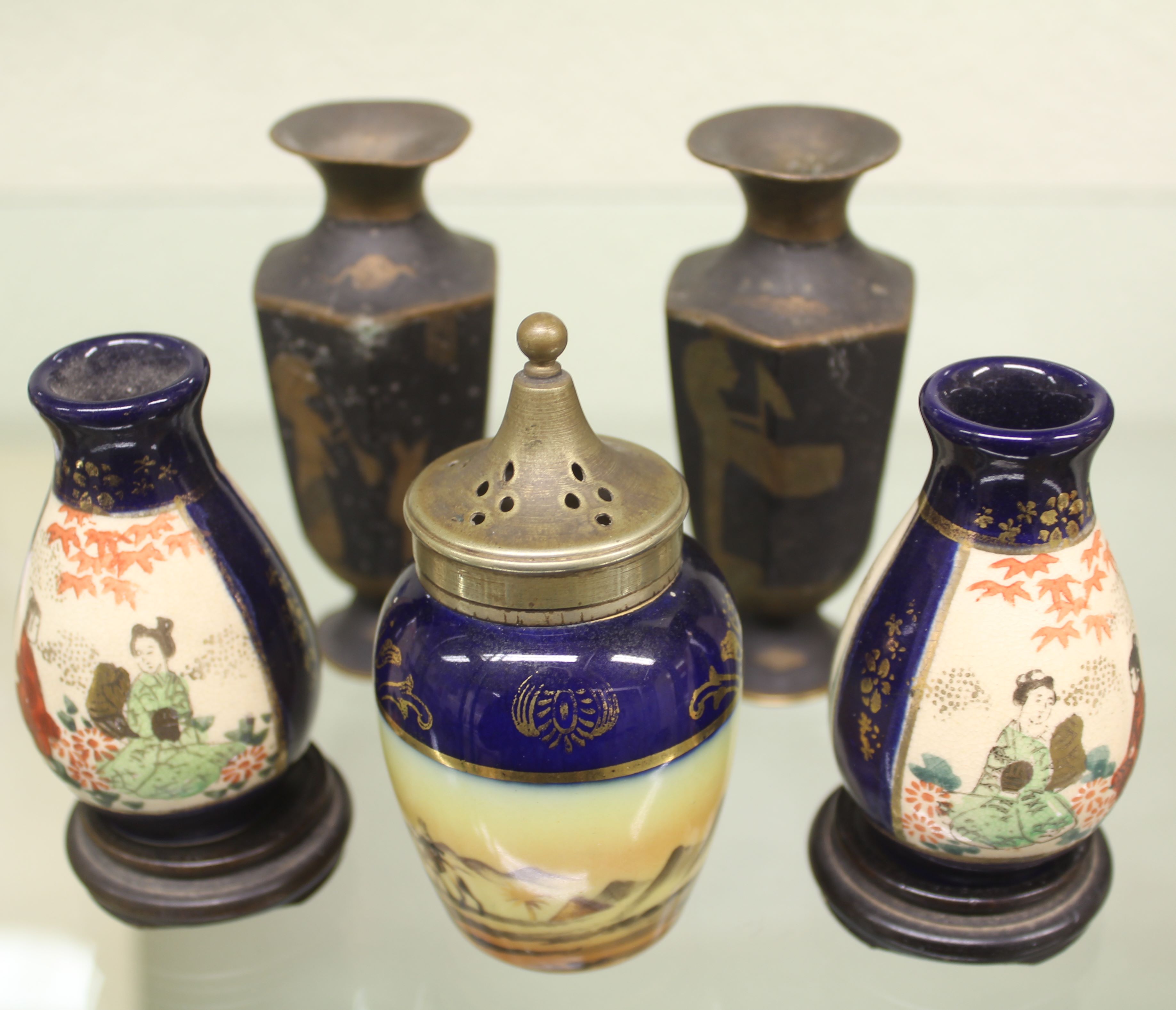 Pair of miniature satsuma vases and wooden stands; a pair of miniature vases, Egyptian motifs with