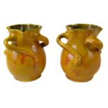 A pair of Barum pottery vases, possibly made for Liberty & Co London, of money purse form, the