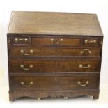 A late George III oak bureau, c1790, the mahogany bordered fall front opening to reveal seven