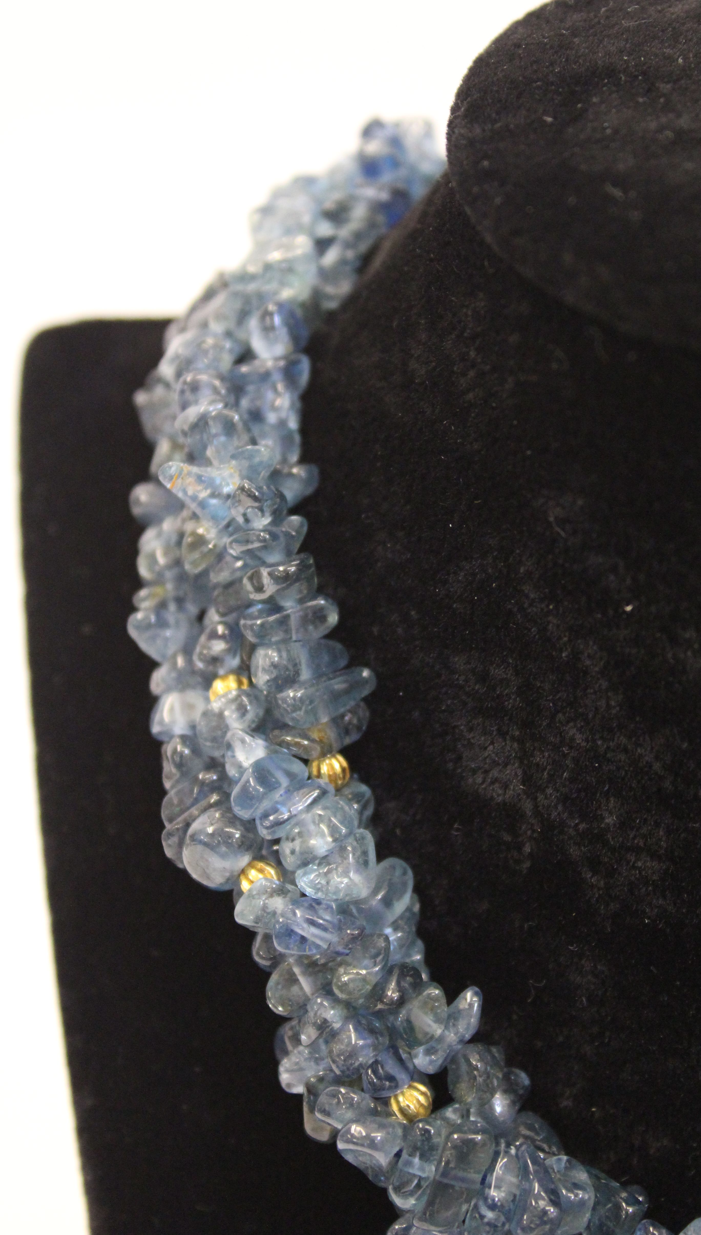 An unusual aquamarine, blue topaz and gold roundell necklace, the four rows of graduated natural - Image 3 of 4