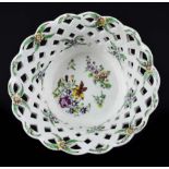 A Bow porcelain basket, c1760, circular with high pierced trellis sides, painted in polychrome