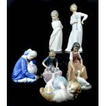 Nao by Lladro - porcelain figures, comprising boy with fly swatter; girl with puppies; girl