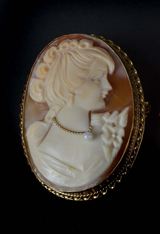 A vintage 9ct gold and shell cameo brooch, carved with a young lady with pearl set necklace, in a