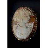 A vintage 9ct gold and shell cameo brooch, carved with a young lady with pearl set necklace, in a