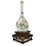 A Japanese porcelain bottle vases finely painted with birds in peony trees; and a carved wood stand,