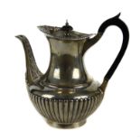 A silver coffee pot, of vase shape, half gadrooned with shell and scroll motif to the upper rim