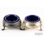 A pair of Victorian circular silver salts, each on three hoof feet with beaded upper rims with