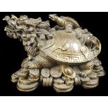 A Chinese Yuanbao coin gilded figural bronze, cast as a Bixi dragon turtle on a pile of couuns and