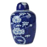A blue and white Chinese porcelain ginger jar and cover, 20thC, ovoid form, decorated with prunus