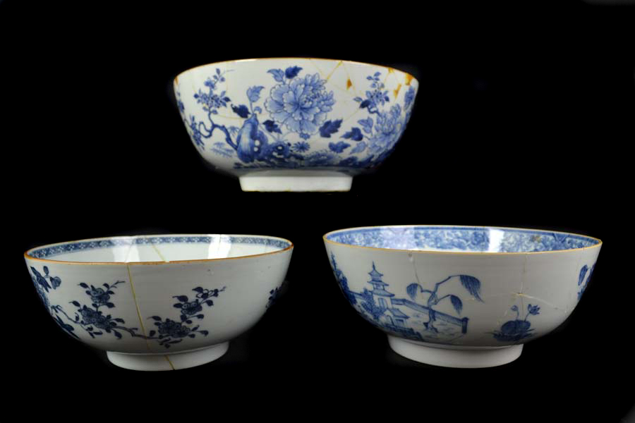 Three Chinese export porcelain blue and white punch bowls, painted with flowering peonies, 35cm