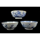 Three Chinese export porcelain blue and white punch bowls, painted with flowering peonies, 35cm