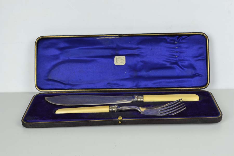 A cased pair of silver plated fish servers, with silver ferrules, Sheffield 1911, makers mark HG
