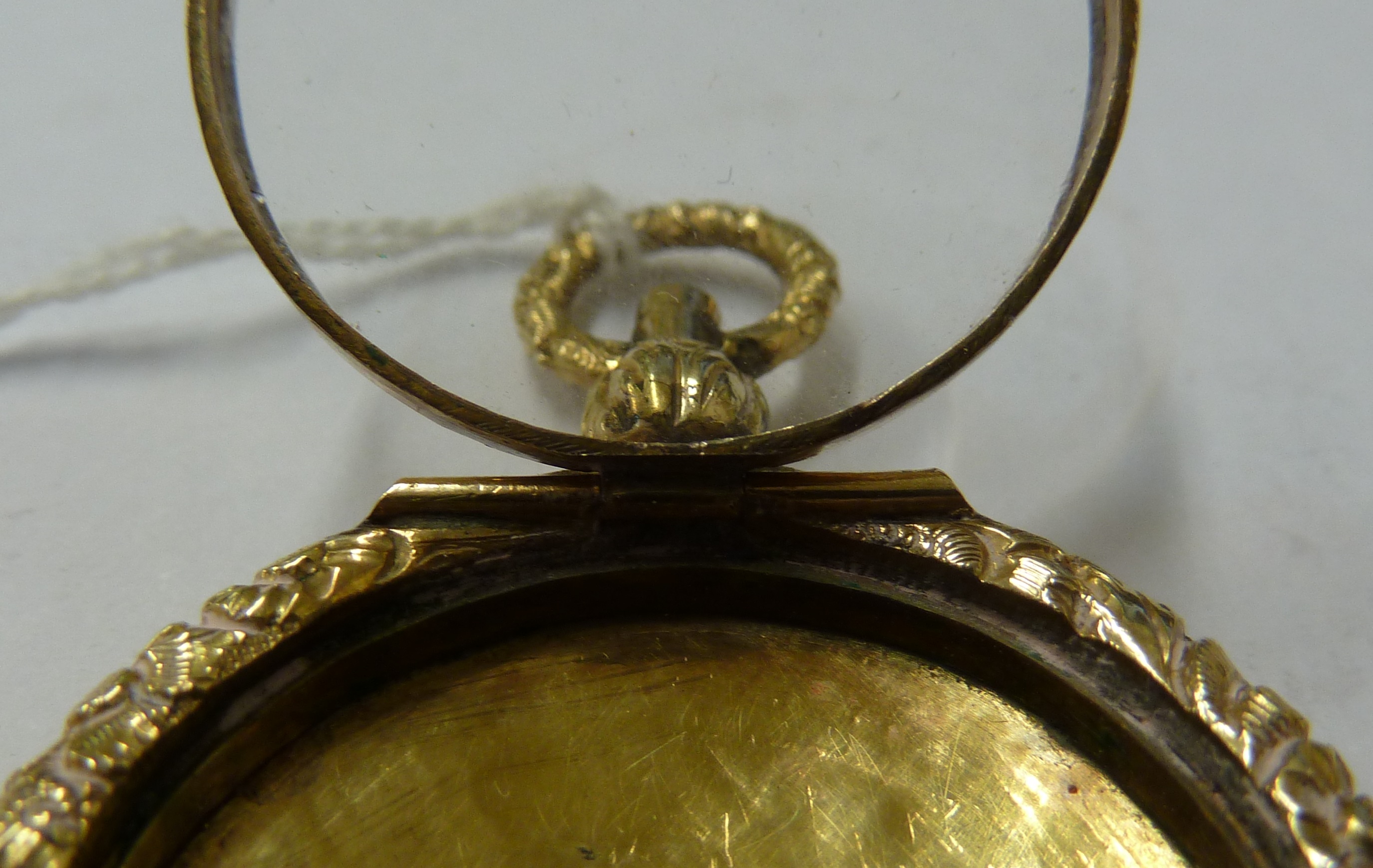 A small 15ct yellow gold locket, c1840, of circular form with carved floral borders - Image 6 of 7