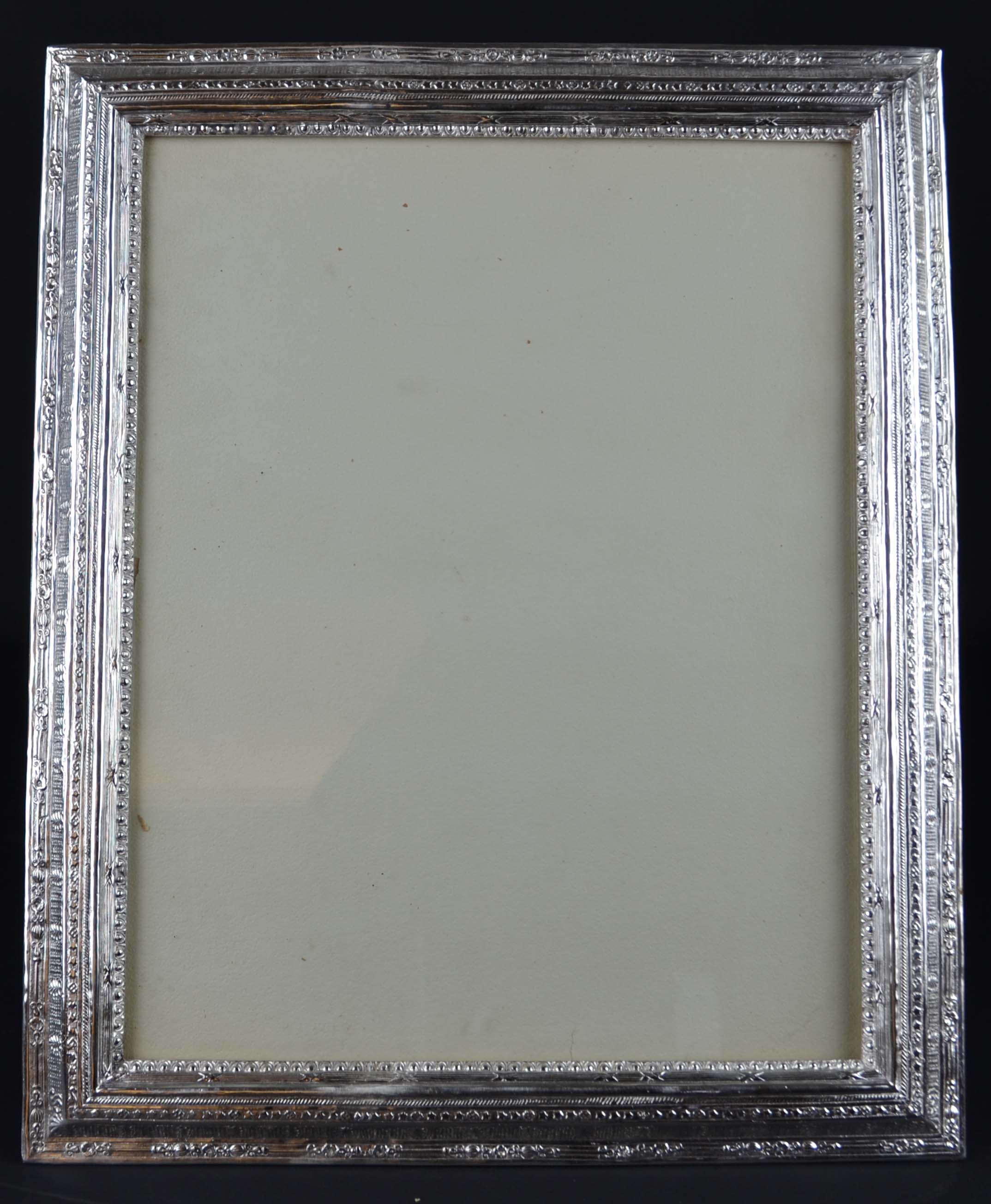 A large silver plated rectangular photograph frame, the copper stepped bevelled frame cast with