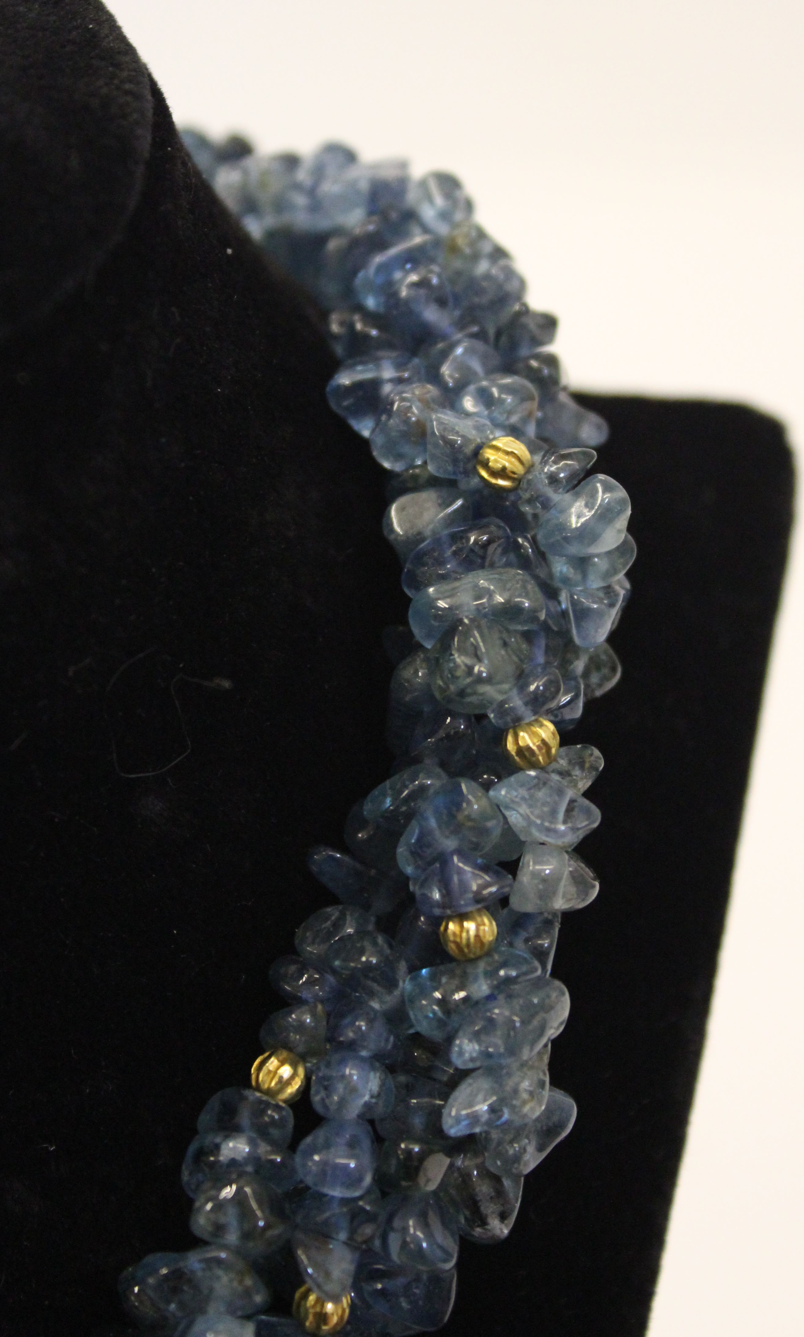 An unusual aquamarine, blue topaz and gold roundell necklace, the four rows of graduated natural - Image 2 of 4