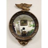 A vintage bulls eye mirror, with ball decorated circular frame with an eagle pediment