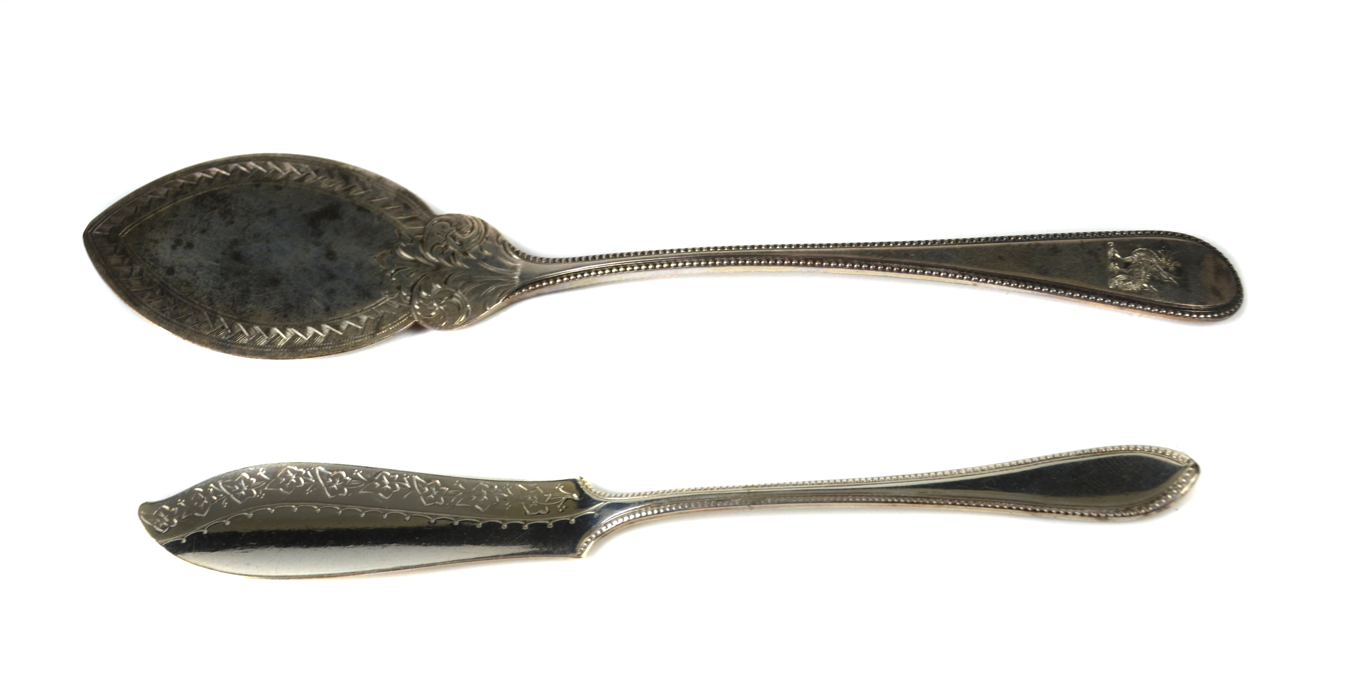 A crested silver flat blade jam spoon, the elliptical blade chased with ozier work with scrolled