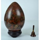 A modern Chinese cloisonné decorative egg, the cloisonné of dark brown tones decorated with floral