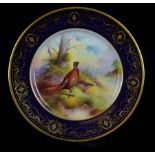 An Aynsley hand painted cabinet plate decorated with a pair of pheasants, signed indistinctly,