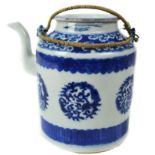 A Chinese blue and white teapot and cover, decorated with roundels formed from scrolled dragons,