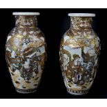 A pair of Japanese satsuma baluster vases, typically decorated with figures within cell diaper and