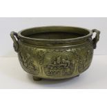 A large Chinese bronze censer, circular, cast with warriors within mirror form cartouches and