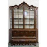 A Dutch burr walnut Delftware or china cabinet, the moulded cornice with rococo shell detail, a pair