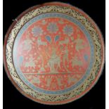 A large Persian brass and enamelled tray, decorated with deities with animals, fish and foliage