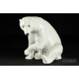 A Continental porcelain figure of a seated polar bear, blue printed B under crown mark, 18cm high