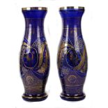 A large pair of Bohemian glass vases, baluster form, cut, gilded and enamelled with foliate sprays