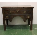 A 18thC oak low boy with one long drawer with one small drawer sitting either side of plain legs,