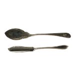 A crested silver flat blade jam spoon, the elliptical blade chased with ozier work with scrolled