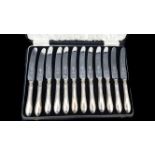 A set of twelve silver handled butter knives with stainless steel blades, Sheffield 1932, makers