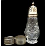 A silver topped cut glass sugar caster, of vase form, Birmingham 1963; and two silver napkin