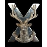 A silver Seaforth Highlanders badge, x form applied with stag head over Cuidich 'n Righ (Aid the