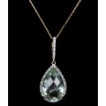 A briolette cut pear shape aquamarine and diamond pendant, within a micro set diamond surround