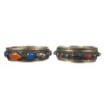 Two Tibetan white metal bangles, set with multi coloured cabouchon stones (2)