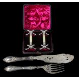 A pair of silver plated fish servers, the pierced blade decorated with foliate scrolls and a pair of