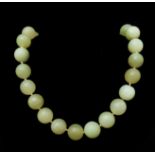 A Chinese slightly graduated row of 39 12mm to 15mm pale whitish green coloured jade beads to a