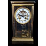 A French four glass mercury pendulum mantle clock, enamel dial with visible escapement and moon