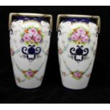 A pair of Noritake porcelain two handled vases, painted with rose and summer flowers swags within