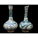 Two Persian pottery bottles, Isnik style, probably Kutahya, one with shaped pouring lip, 31cm max (