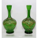 A pair of Continental emerald green glass bottle vases, of small size, enamelled and gilded in Moser