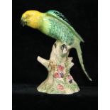 A Beswick pottery figure of a parrot, designed by Arthur Greddington, green and yellow plumage on