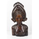 A Balinese carved wooden bust, of a young woman, with elaborate headress, 33cm high