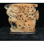 A Chinese carved soapstone brush stand, of flattened vase form carved and pierced with dragon,