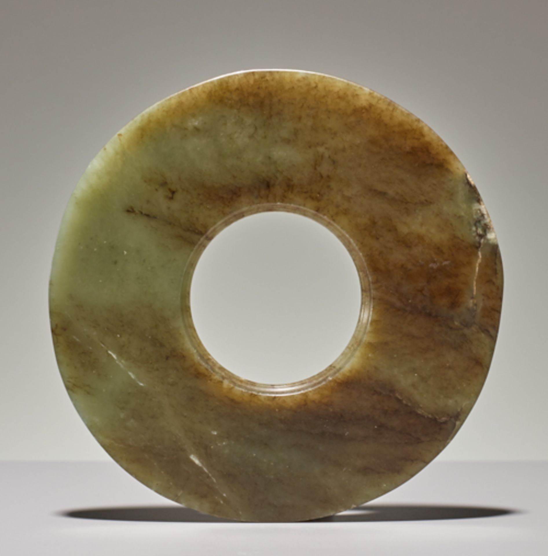 DISC IN SEMI-TRANSLUCENT JADEJade. China, Late Neolithic period, Qijia culture, c.2200-1900 - Image 2 of 5