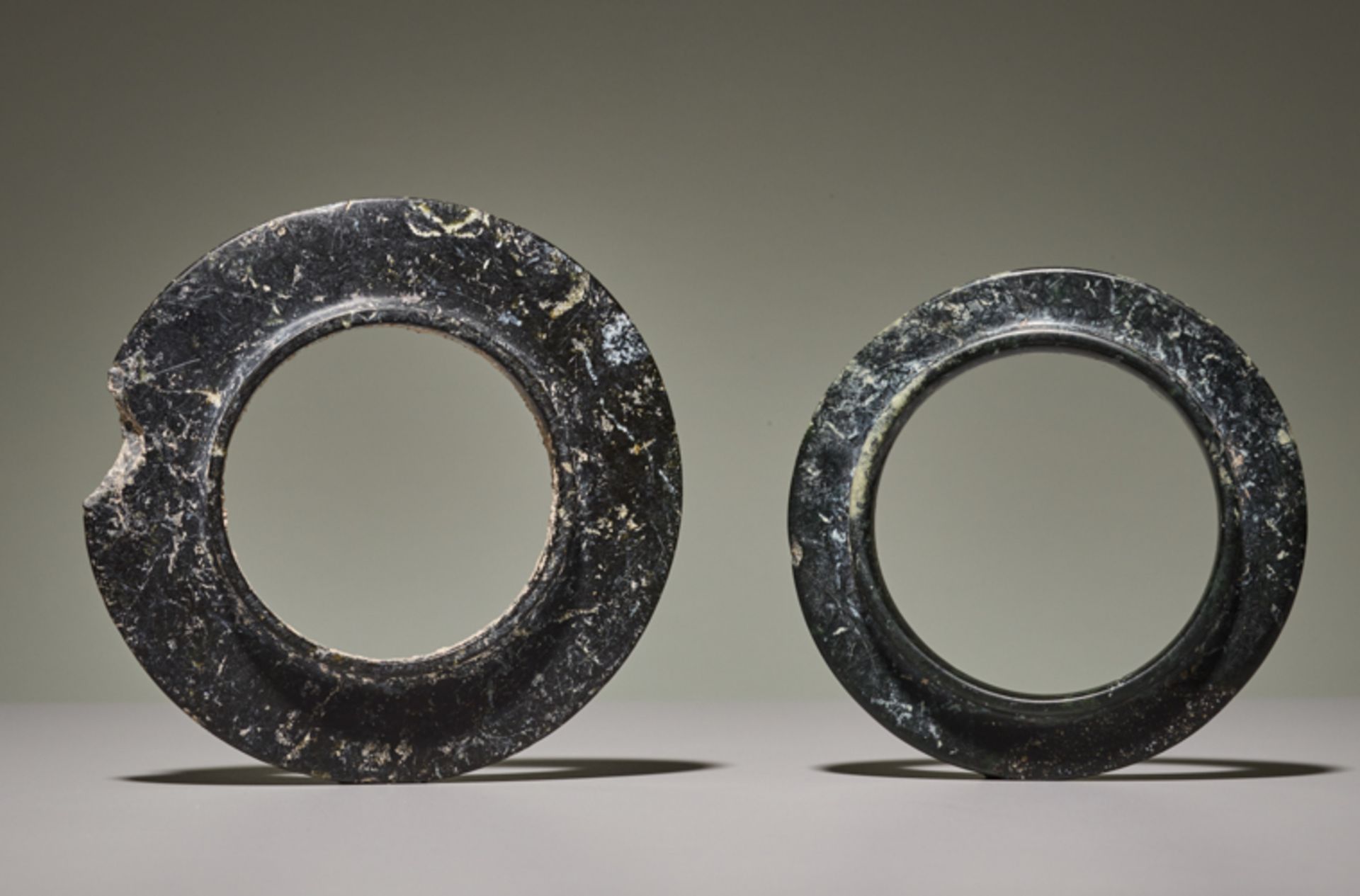 PAIR OF COLLARED YUAN RINGSJade. China, Late Shang dynasty, ca. 1200 BCThe two collared rings in the - Image 2 of 6