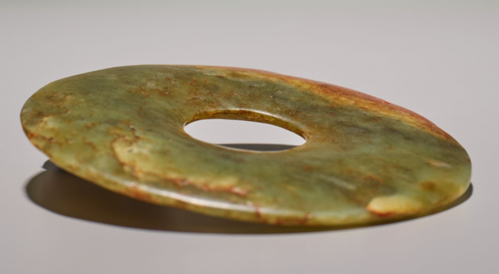 SMALL DISCJade. China, Late Neolithic period, early Bronze age, c.2500-2000 BCSmall disc in light - Image 4 of 4