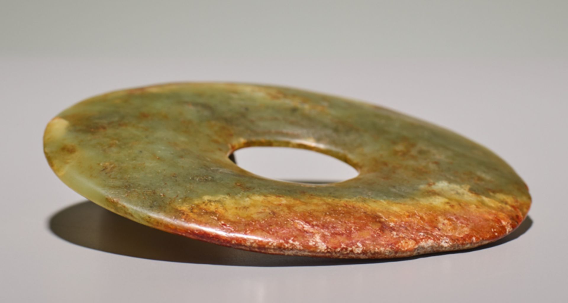 SMALL DISCJade. China, Late Neolithic period, early Bronze age, c.2500-2000 BCSmall disc in light - Image 3 of 4